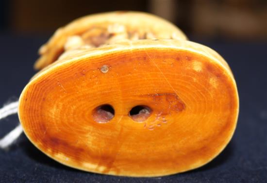A carved ivory of figures under a crab